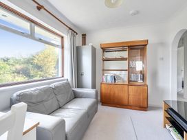 A living room with a sofa and bookcase at Sleeps 9 KingBeds Family Friendly in Pityme near Penmayne