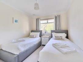 A bedroom with two beds and a window at Sleeps 9 KingBeds Family Friendly, Pityme near Penmayne