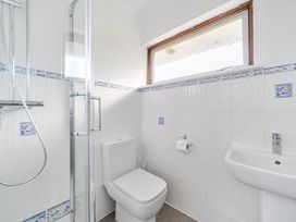 A bathroom with shower, toilet, and sink at Sleeps 9 KingBeds Family Friendly in Pityme near Penmayne