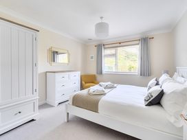 A bedroom with a bed and dresser at Sleeps 9 KingBeds Family Friendly in Pityme near Penmayne
