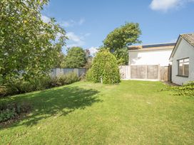 A garden with trees and a shed at Sleeps 9 KingBeds Family Friendly in Pityme near Penmayne