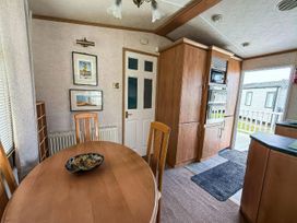 A dining room with a table and chairs at Super 2 bed 6 berth caravan pets go free Hunstanton