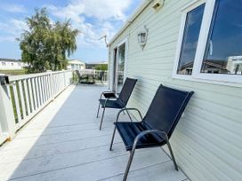A deck with chairs at Super 2 bed 6 berth caravan pets go free in Hunstanton