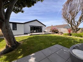 A garden with a house and seating area at the property in an outdoor setting