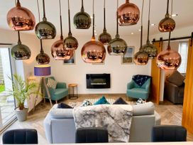 A living room with pendant lights and a fireplace