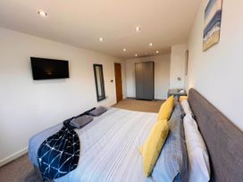 A bedroom with a bed and television at The Old Barn in Manchester