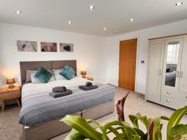 A bedroom with a double bed and wardrobe at The Old Barn in Manchester