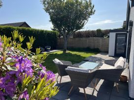 A garden with outdoor seating and a tree at the property located in the area