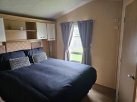 A bedroom with a bed and shelves at the property in an unknown location