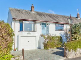 A house with a garage and garden at Lothlorien in Grange over Sands