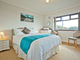 A bedroom with a bed and bedside table at Lothlorien in Grange over Sands