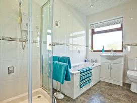 A bathroom with shower and bathtub at Lothlorien in Grange over Sands