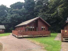 A wooden lodge with a deck area at Stunning 2 Bedroom Pet Friendly Lodge in Bridlington