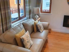 A living room with a sofa and lamp at Stunning 2 Bedroom Pet Friendly Lodge in Bridlington