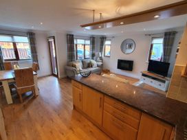 A living room with a sofa and television at Stunning 2 Bedroom Pet Friendly Lodge in Bridlington