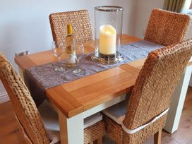 A dining table with a wine bottle and glasses at Stunning 2 Bedroom Pet Friendly Lodge in Bridlington