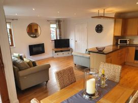 A living room with a sofa and dining table at Stunning 2 Bedroom Pet Friendly Lodge in Bridlington