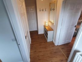 A hallway with a sideboard and a mirror at Stunning 2 Bedroom Pet Friendly Lodge in Bridlington