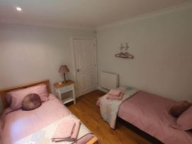A bedroom with two beds and a small table at Stunning 2 Bedroom Pet Friendly Lodge in Bridlington