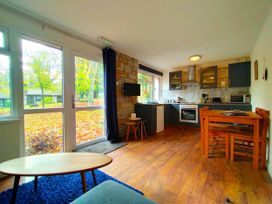 A kitchen with a dining table and chair at Painters Cottage 2Bed Chalet Free Leisure Passes Near St Ives