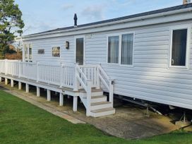 A mobile home with steps and a deck at Cayton Bay Lodge Parkdean Resorts in Scarborough