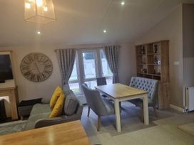 A living room with a sofa and dining table at Cayton Bay Lodge Parkdean Resorts in Scarborough