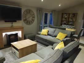 A living room with a sofa and television at Cayton Bay Lodge Parkdean Resorts, Scarborough