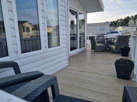An outdoor space with chairs and a table at Cayton Bay Lodge Parkdean Resorts Scarborough