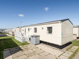 A mobile home with steps and storage box at Sleeps 8 Communal Spa Access Parking in Rhyl