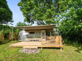 A trailer on a wooden deck in a garden at Sleeps 2 - Private Hot Tub - Fire Pit, St. Dogmaels near Cardigan