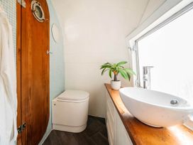 A bathroom with a toilet, sink, and a plant at Sleeps 2 - Private Hot Tub - Fire Pit, St. Dogmaels near Cardigan