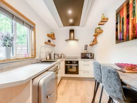 A kitchen with appliances and a table at Luxury 2 bedroom Lodge in rural lincolnshire