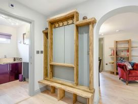 A hallway with a coat rack and bench at Luxury 2 bedroom Lodge in rural lincolnshire, Kirton