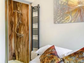 A shower and bed with decorative cushions at Luxury 2 bedroom Lodge in rural lincolnshire