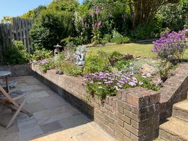A garden with flowers and a statue at Bungalow Sleeps 2 Parking in Newquay