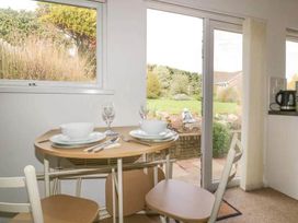 A dining area with a table set for two at Bungalow Sleeps 2 Parking in Newquay