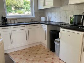 A kitchen with a sink and appliances at Bungalow Sleeps 2 Parking in Newquay