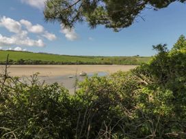 A view of water with a boat and sandy shore at Bungalow Sleeps 2 Parking Newquay