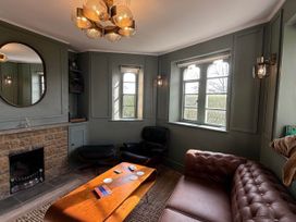A living room with a coffee table and sofa at Cotswolds Castle Sleeps 8 with Enclosed Garden, Banbury