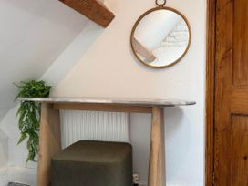 A table with a mirror and a stool at Cotswolds Castle Sleeps 8 with Enclosed Garden in Banbury