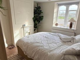 A bedroom with a bed and potted plant at Cotswolds Castle Sleeps 8 with Enclosed Garden, Banbury