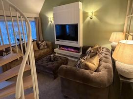 A living room with a sofa and television at 2 Bed Cottage Sleeps 4 Parking Wifi Darnick