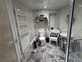 A bathroom with toilet, sink, and towel radiator at 2 Bed Cottage Sleeps 4 Parking Wifi Darnick