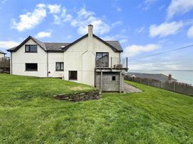 A house with a balcony and garden at Porthleven Coastal Retreat with 5 Bedrooms in Porthleven