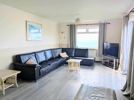 A living room with a sofa and television at Porthleven Coastal Retreat with 5 Bedrooms in Porthleven