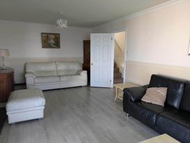 A living room with sofas and a staircase at Porthleven Coastal Retreat with 5 Bedrooms Porthleven