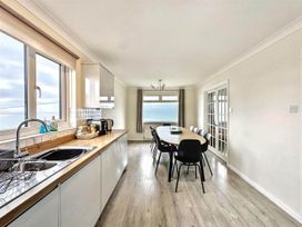 A kitchen with a dining table and chairs at Porthleven Coastal Retreat with 5 Bedrooms in Porthleven
