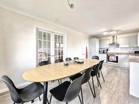 A dining room with a table and chairs at Porthleven Coastal Retreat with 5 Bedrooms in Porthleven