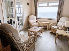 A living room with armchairs and a coffee table at Porthleven Coastal Retreat with 5 Bedrooms in Porthleven