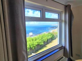 A living room with a view of the ocean at Porthleven Coastal Retreat with 5 Bedrooms in Porthleven